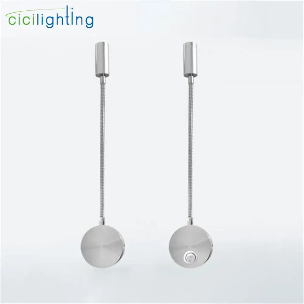 A pair of silver flexible gooseneck led wall sconces with adjustable metallic arms and circular bases for bedroom reading