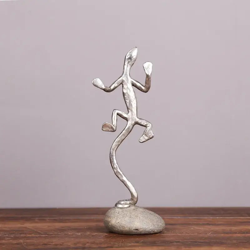 Silver metallic gecko lizard resin figurine in a dynamic pose on textured stone base for living room decorbites decor