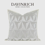 A silver-toned pillow cover with geometric embroidery from davinrich home collection for luxe living room decorbites style
