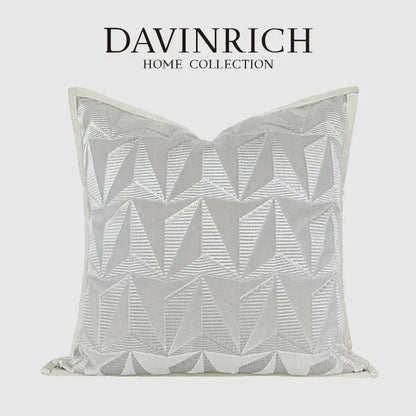 A silver-toned pillow cover with geometric embroidery from davinrich home collection for luxe living room decorbites style