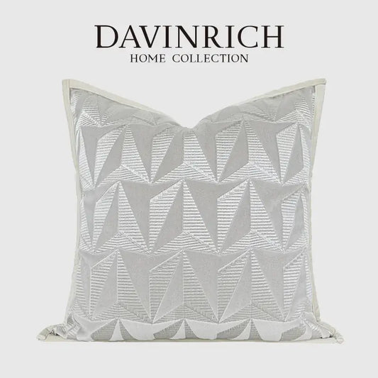 A silver-toned pillow cover with geometric embroidery from davinrich home collection for luxe living room decorbites style