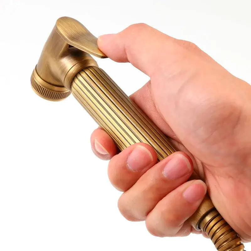 Antique brass-finished decorbites golden bidet sprayer with ribbed grip and textured nozzle for handheld bathroom use