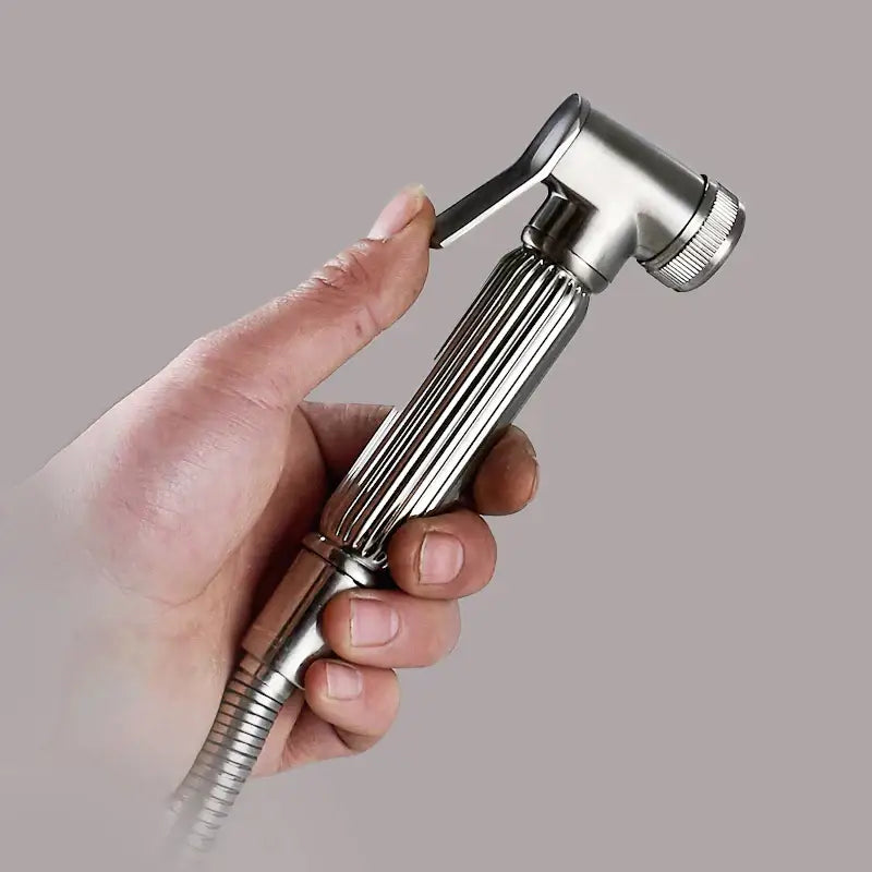 A sleek silver stainless steel bidet sprayer with a ribbed handle and textured trigger for bathroom use