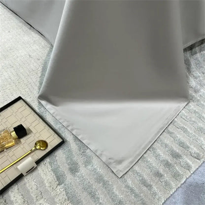 A smooth white satin tablecloth with subtle sheen and finished edges in a silver gray 1200tc embroidery egyptian cotton bedding set