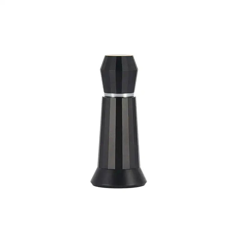 Black faceted glass perfume bottle with silver band next to silver hexagonal aluminum espresso distributor wdt tool kitchen accessory