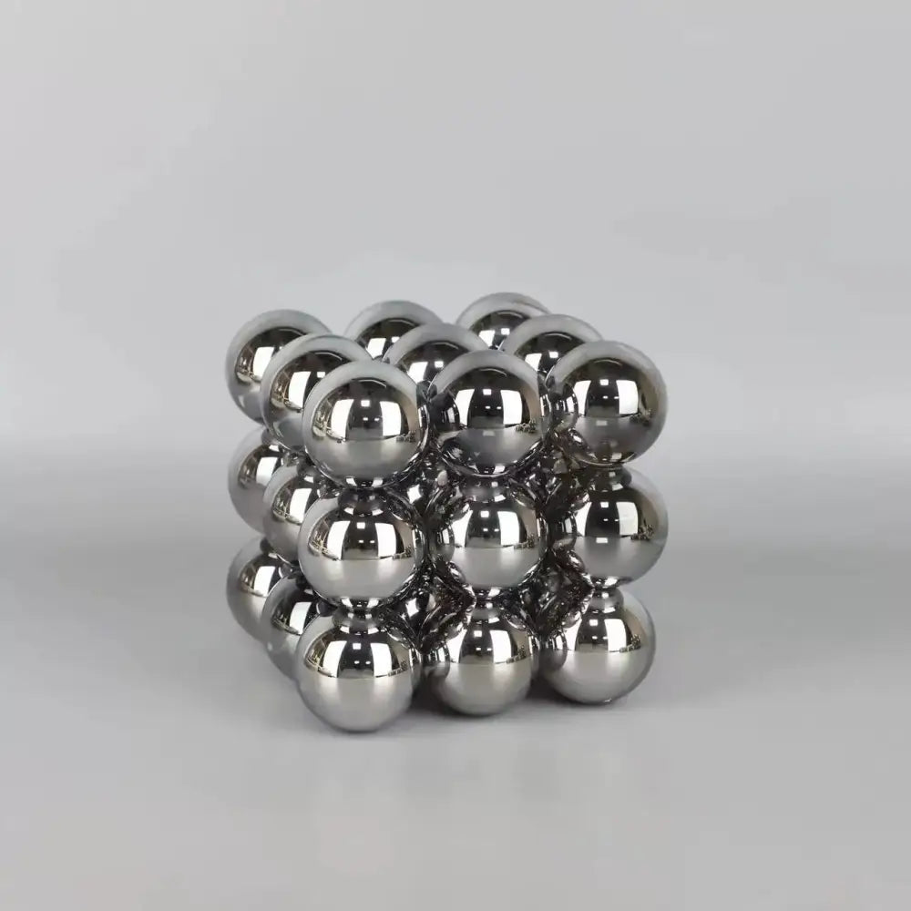 A cube-shaped stack blocks sculpture made of polished silver crystal glass ball spheres for living room decor