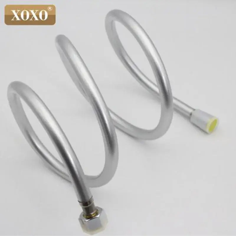 Silver pvc flexible shower hose with metallic spiral connectors and yellow-tipped end branded xoxo for bathroom use