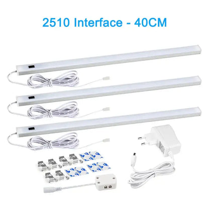 Three white led strip cabinet lights with pir motion sensor and mounting hardware for use in living spaces and kitchens