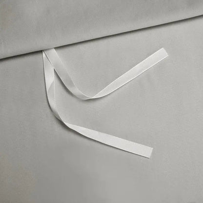 A smooth white satin ribbon on soft gray fabric showcasing the silver satin egyptian cotton bedding set decorbites 1000tc egyptian