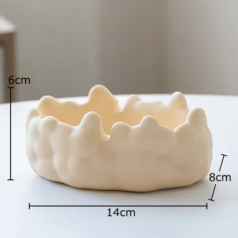 Cream-colored ceramic planter with wavy crown-like rim and rounded base for decorbites ceramic bubble clouds decor
