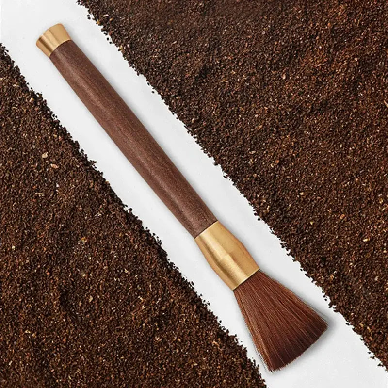 A sleek silver textured espresso brush with wooden handle and dark brown bristles for coffee grinder cleaning