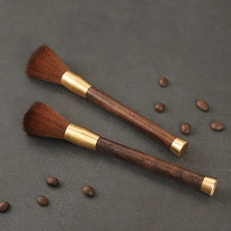 Two elegant wooden-handled espresso brushes with brass accents and dense reddish-brown bristles for coffee grinder cleaning