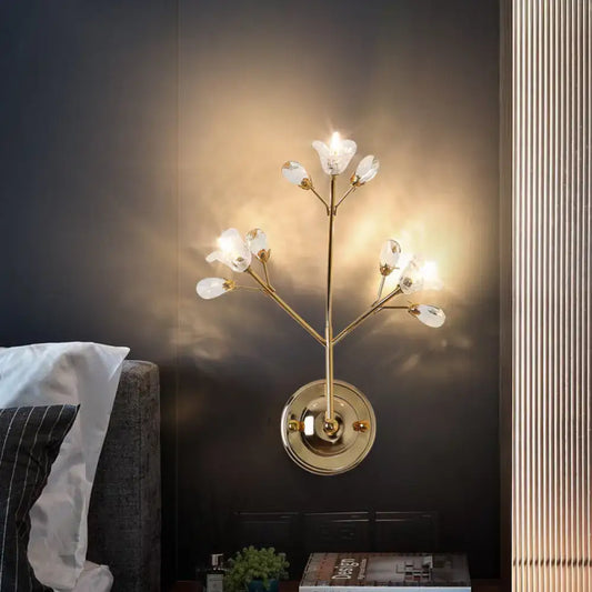 Simple gold crystal flowers wall sconce with delicate branch-like arms and clear crystal flower light fixtures for bedroom