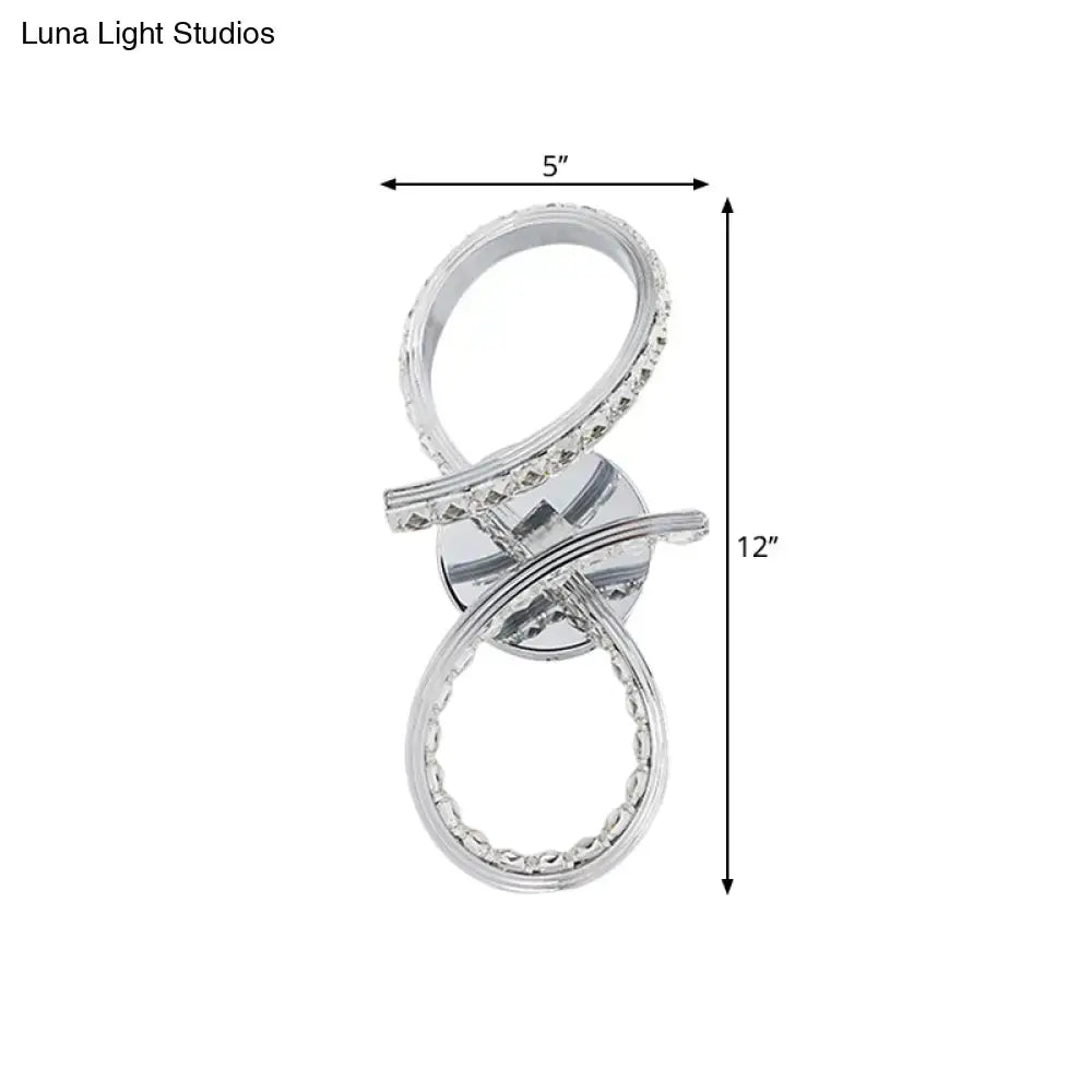 Simple led chrome infinity wall sconce with silver cut crystal deco accents and warm white light for bedroom use