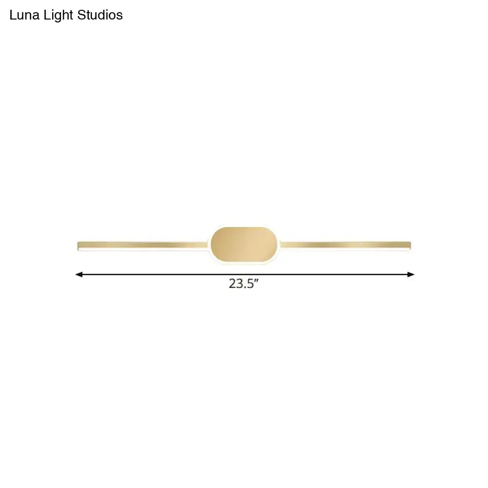 A sleek gold metallic wall mounted vanity sconce with a simple style and oval central accent for bedroom use