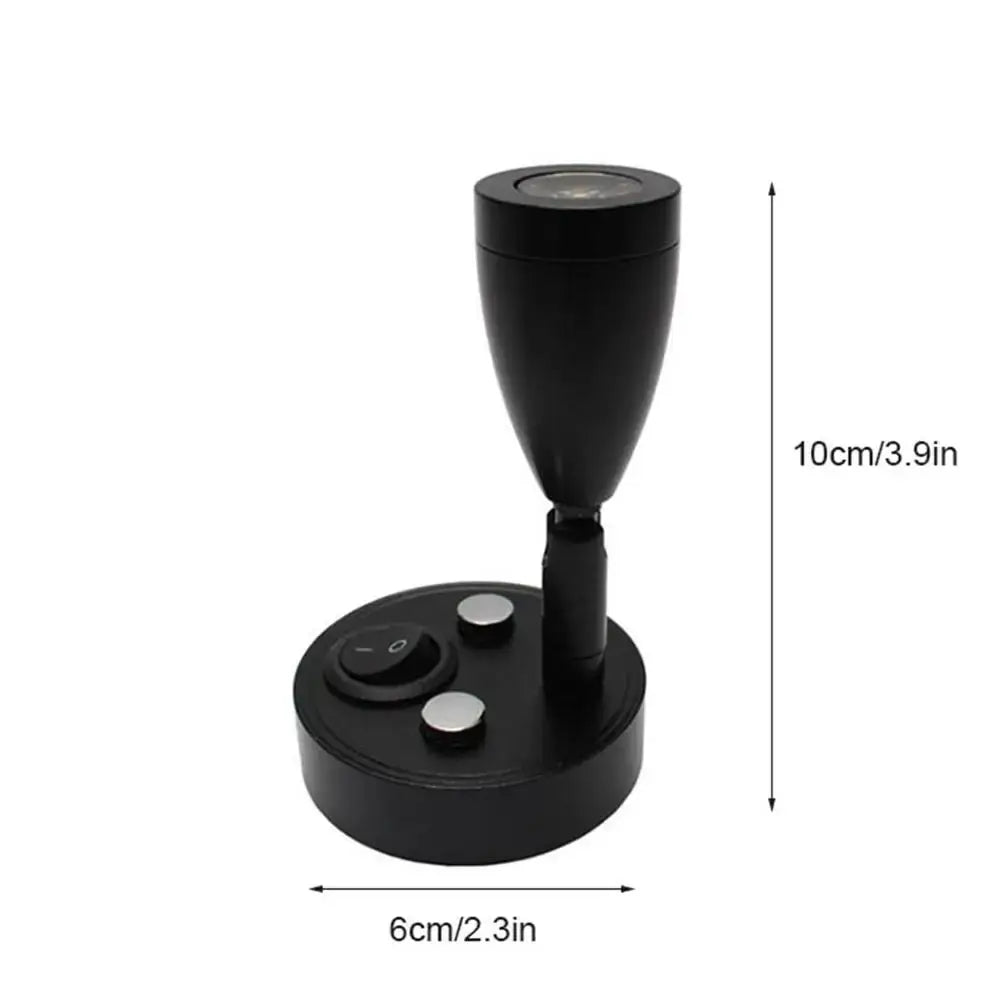 Sleek black adjustable led reading lamp with circular base and silver buttons for rv and bedroom interior use