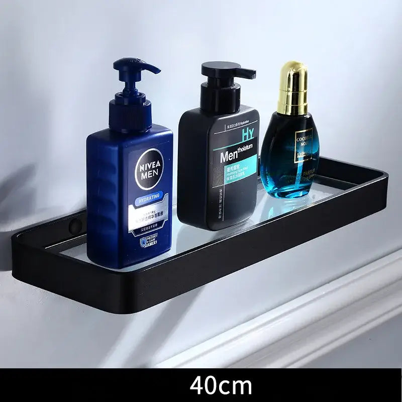 Sleek black aluminum glass shelf with matte finish holding three grooming products for bathroom storage decorbites black aluminum