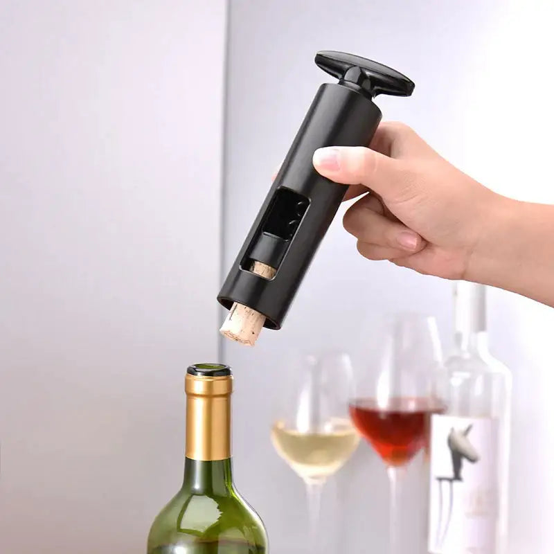 Sleek black metal decorbites corkscrew with cylindrical handle and visible cork extraction mechanism premium kitchen tool