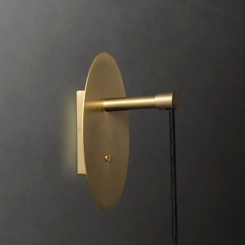 Brass circular led wall light with crystal led elements and black cord by decorbites for bedroom and living room decor
