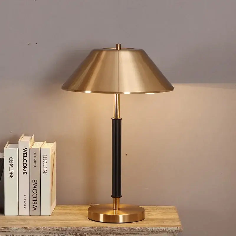 Brass-finished table lamp with sleek conical shade and black leather-wrapped column for decorbites copper table lamp