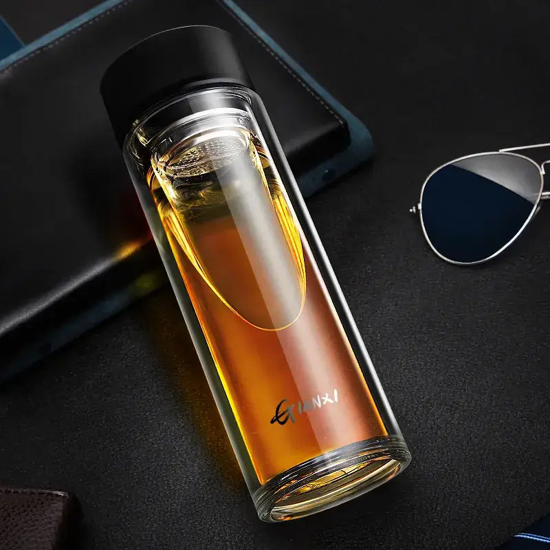 Sleek double-walled glass water bottle with filter black lid filled with amber liquid featuring gianxi brand name