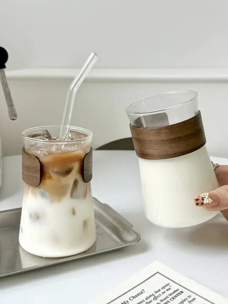 A sleek transparent glass iced latte cup with a warm brown wood band for iced latte coffee decorbites glass iced use