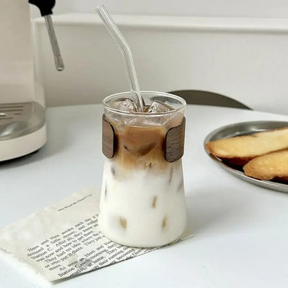 A clear glass iced latte tumbler with wooden wrap filled with iced latte coffee for stylish decorbites glass iced use