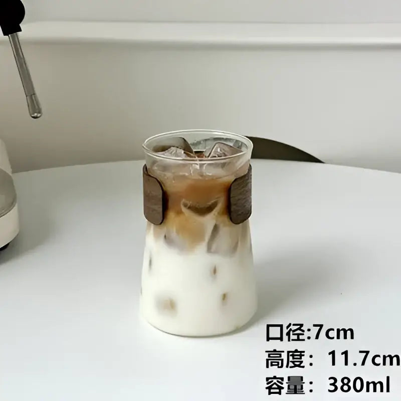 Sleek decorbites glass iced latte coffee cup with clear glass, brown wooden handle band, and layered iced drink
