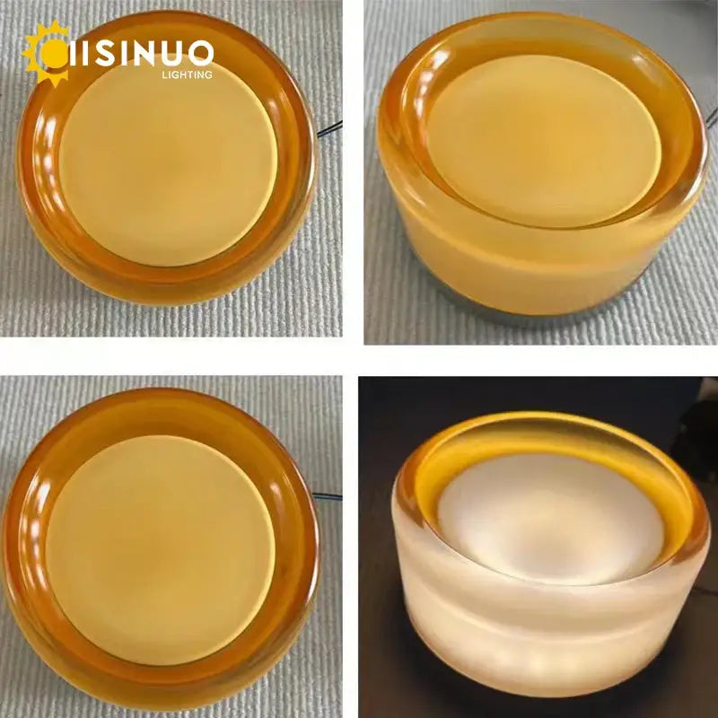 Amber-colored translucent glass round wall sconce with glossy finish and concentric ring design for bathroom use