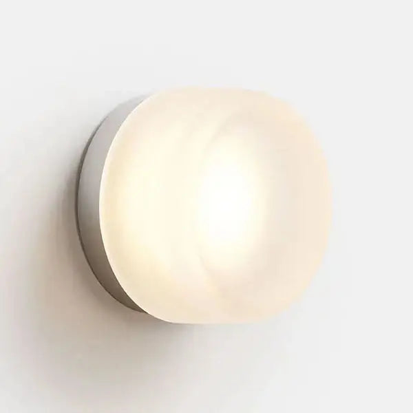 Sleek gold round wall sconce with frosted glass globe and brushed metal base for modern minimalist lighting