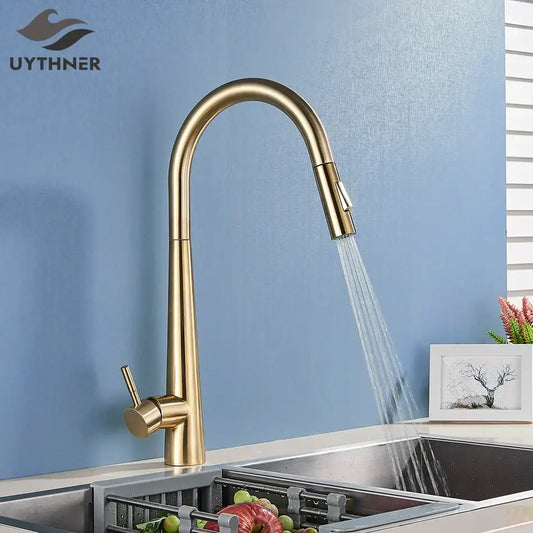 Sleek gold swivel kitchen faucet with pull down sprayer featuring a gold-toned curved spout for decorbites gold swivel