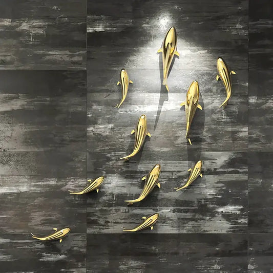 Sleek goldfish resin wall hanging with metallic gold finish and streamlined design for elegant living room decorbites goldfish resin decor