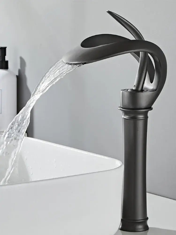 Matte black brass basin faucet with sleek waterfall design and curved spout for modern bathroom decorbites black brass