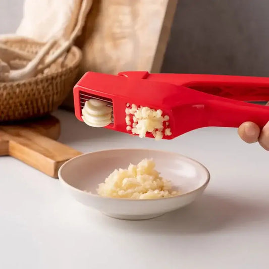 Sleek red manual garlic crusher with ergonomic design by decorbites garlic crusher for efficient kitchen grinding