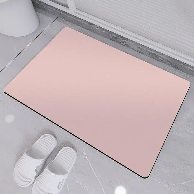 A sleek rectangular pink rubber non-slip bath rug with black border designed for diatom ooze bath use