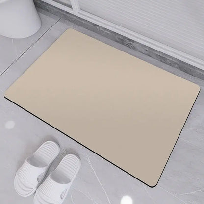 Beige rectangular diatom ooze bath rug with black border designed as a non-slip bathroom mat
