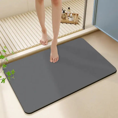 A sleek dark gray rectangular diatom ooze bath rug with rounded corners and a smooth non-slip surface for bathroom use