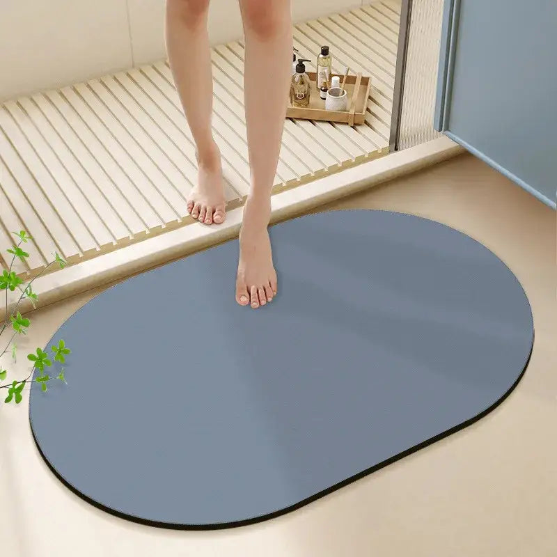 A sleek oval-shaped gray diatom ooze bath rug with black border for non-slip bathroom use