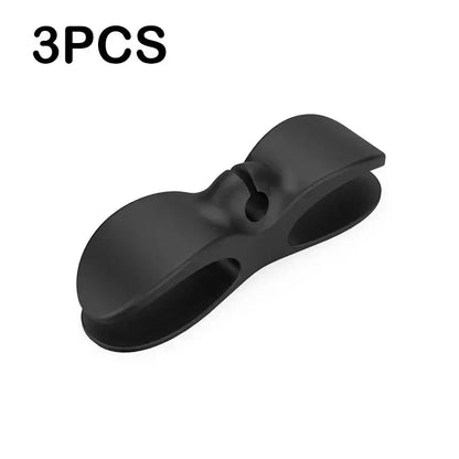 Black plastic decorbites cord winder cable organizer with sleek bow-shaped design and two curved clamping arms