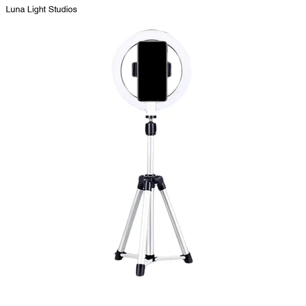 Sleek silver and white circular fill-in lamp with a white ring light mounted on a silver tripod and black phone clamp