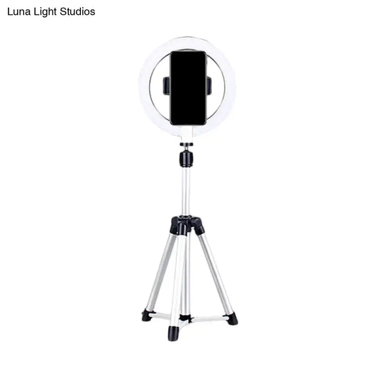 Sleek silver and white circular fill-in lamp with a white ring light mounted on a silver tripod and black phone clamp
