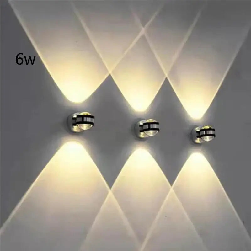 Three sleek silver and black crystal LED wall light sconces emit warm geometric light patterns for living room decorbites crystal led