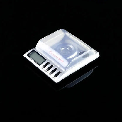 Sleek silver decorbites digital milligram gram scale with white body, clear plastic platform, and four black buttons for precision weighing