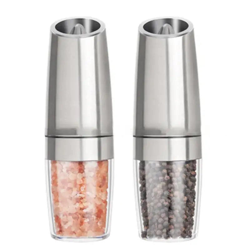 Sleek silver stainless steel electric pepper and salt grinder set with clear glass bases containing pink Himalayan salt and black peppercorns
