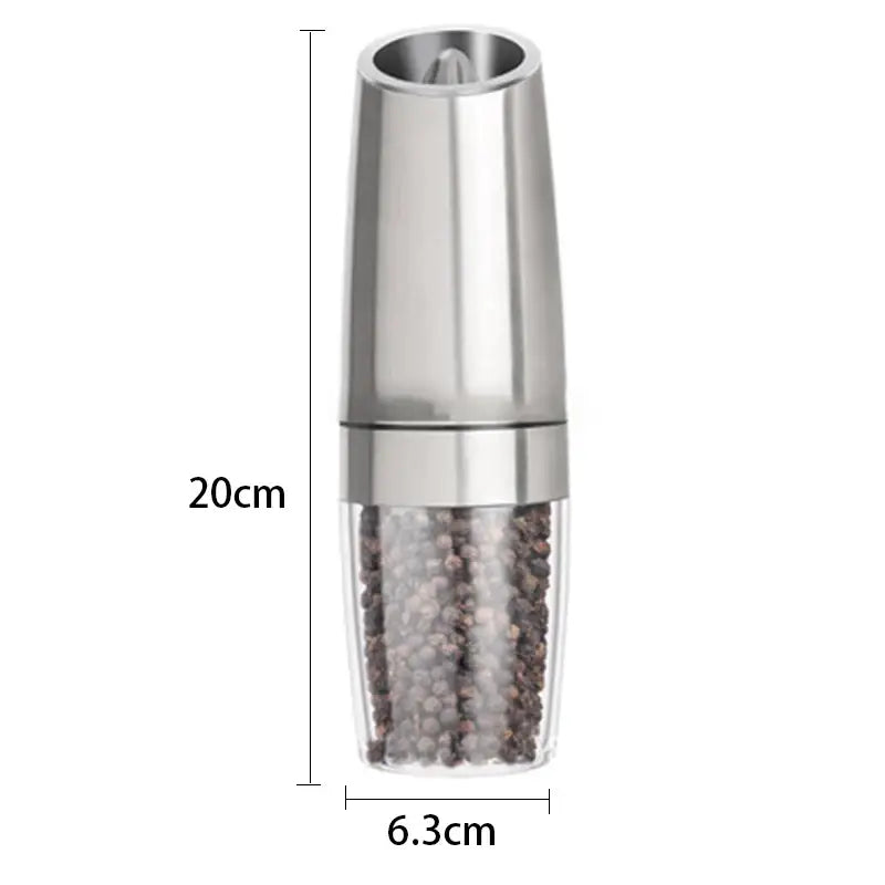 A sleek silver electric pepper mill with brushed stainless steel body in a salt grinder set for kitchen use