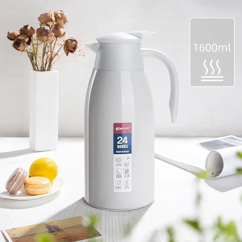 A sleek white insulated 1600ml decorbites insulavacuum bottle with handle and spout for kitchen use