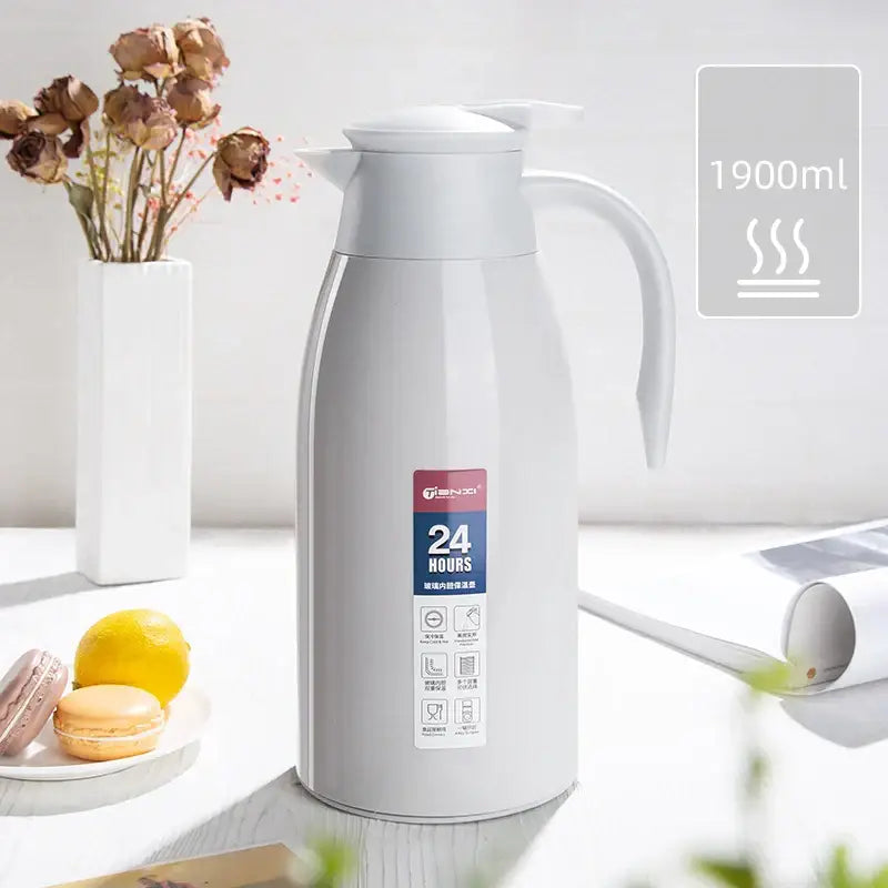 A sleek white 1900ml decorbites insulavacuum bottle with stainless steel body and ergonomic handle for kitchen use