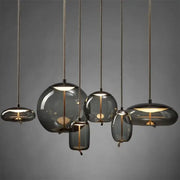 Sleek smoked glass led chandelier with warm golden filaments and textured cords for living room pendant lighting