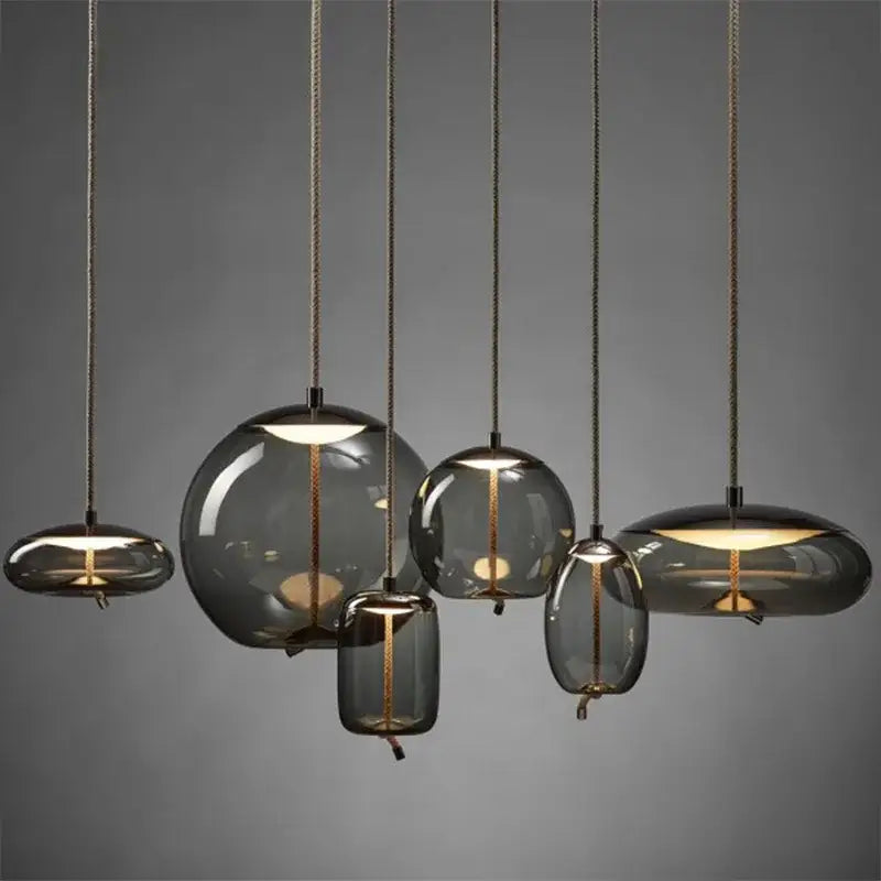 Sleek smoked glass led chandelier with warm golden filaments and textured cords for living room pendant lighting