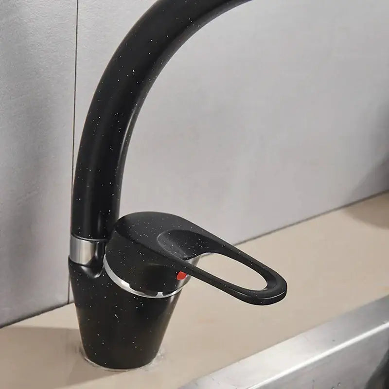 Sleek speckled black and chrome single handle kitchen faucet with curved spout decorbites black single design